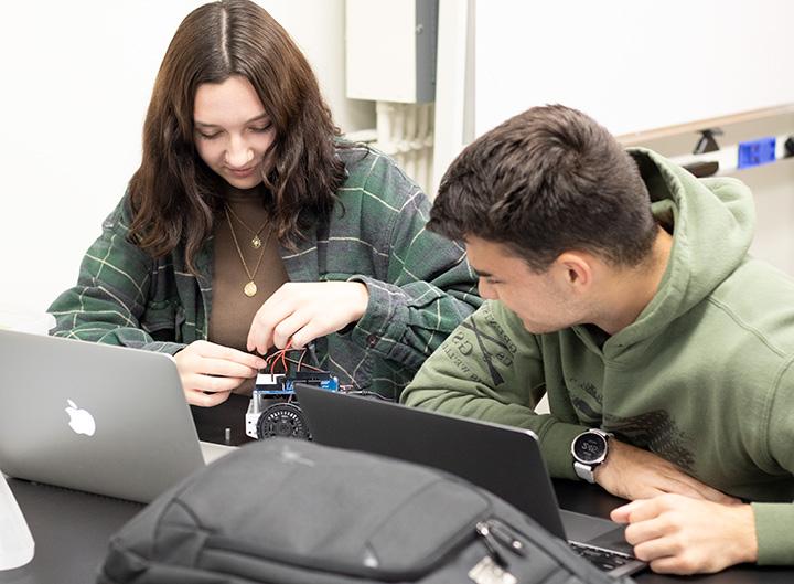 Male and female student in Makerspace for robotics course